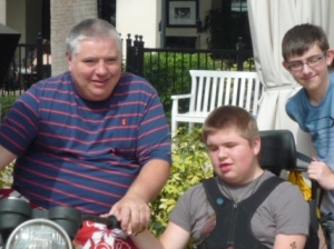 Matthew with his Dad and stepbrother in the sun in Orlando